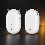 Two LumiTrack Lite curtain openers with metal rail hooks on a graphite background
